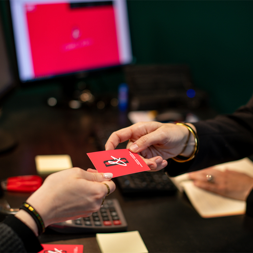 mains qui échangent une carte de visite